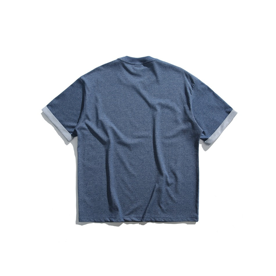 Back view of a blue short-sleeve T-shirt with pale folded sleeve cuffs.