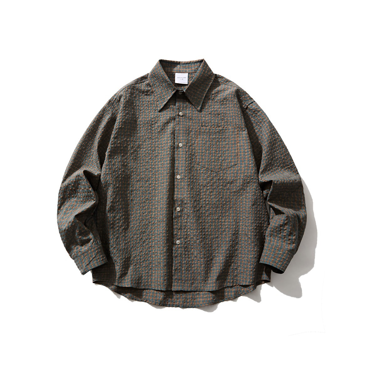 Green check long-sleeve button-up shirt with chest pocket, flat lay front view