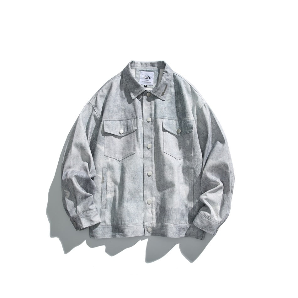 Light gray washed-look denim-style jacket laid flat, with chest flap pockets and snap-button front