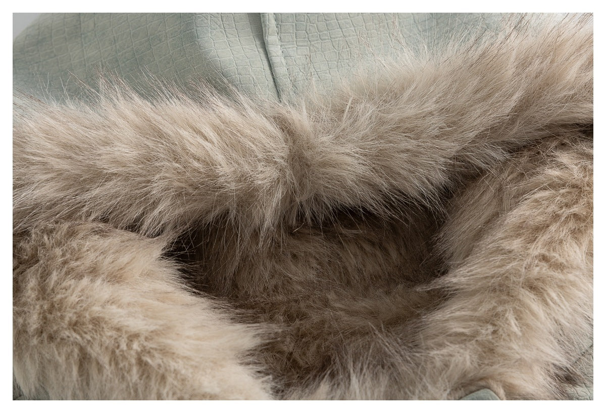 Extreme close-up of the beige fur lining and trim inside the jacket's hood.