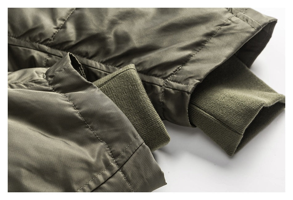 Close-up of an olive-gray jacket sleeve with a ribbed knit cuff.
