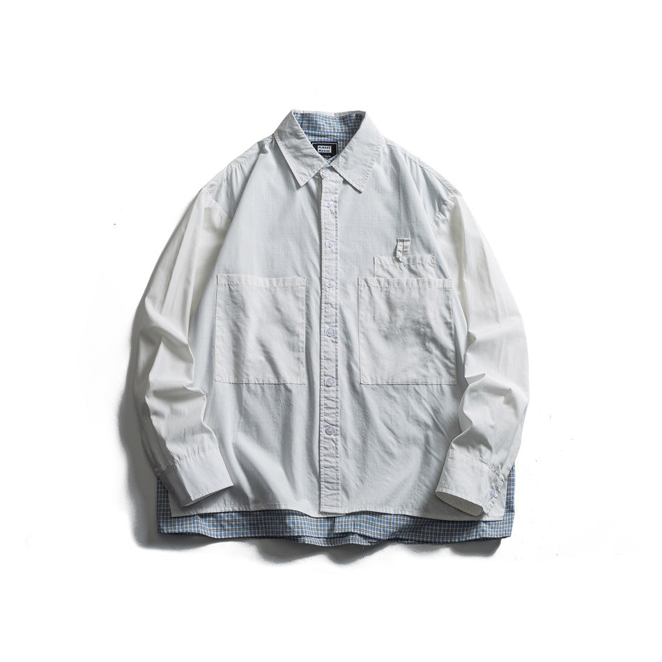 Off-white button-up shirt with large patch pockets and a blue plaid layer showing at the collar and hem