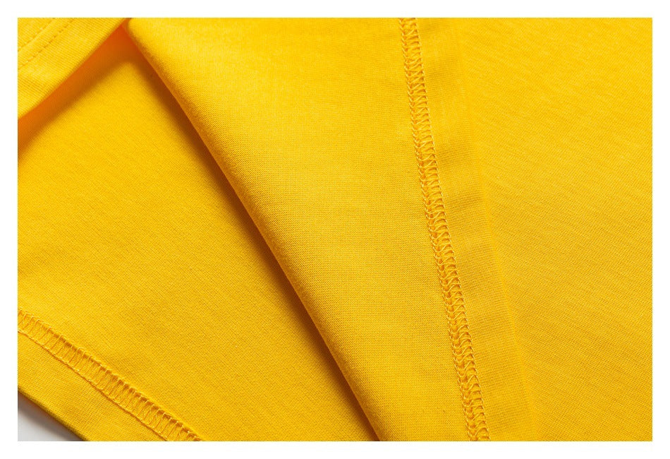 Close-up of bright yellow fabric with visible overlock seams and stitching.
