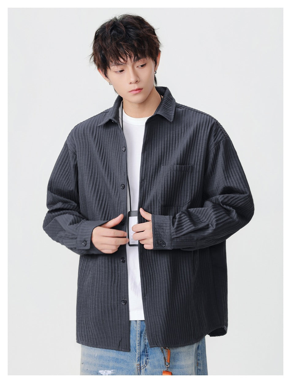 Model wearing a charcoal pinstriped button-up shirt with a pointed collar, front buttons, and chest pocket.
