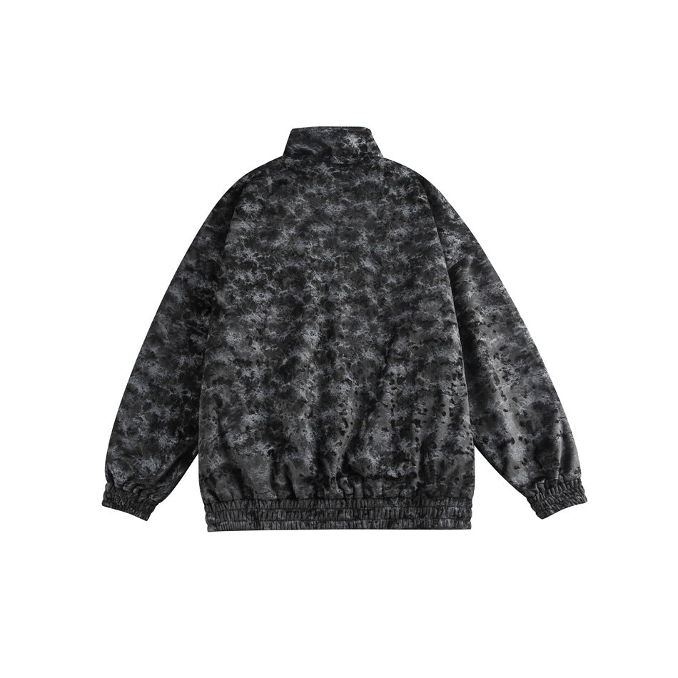 Back view of a black and gray mottled zip-up jacket with a high collar and elastic cuffs and hem.