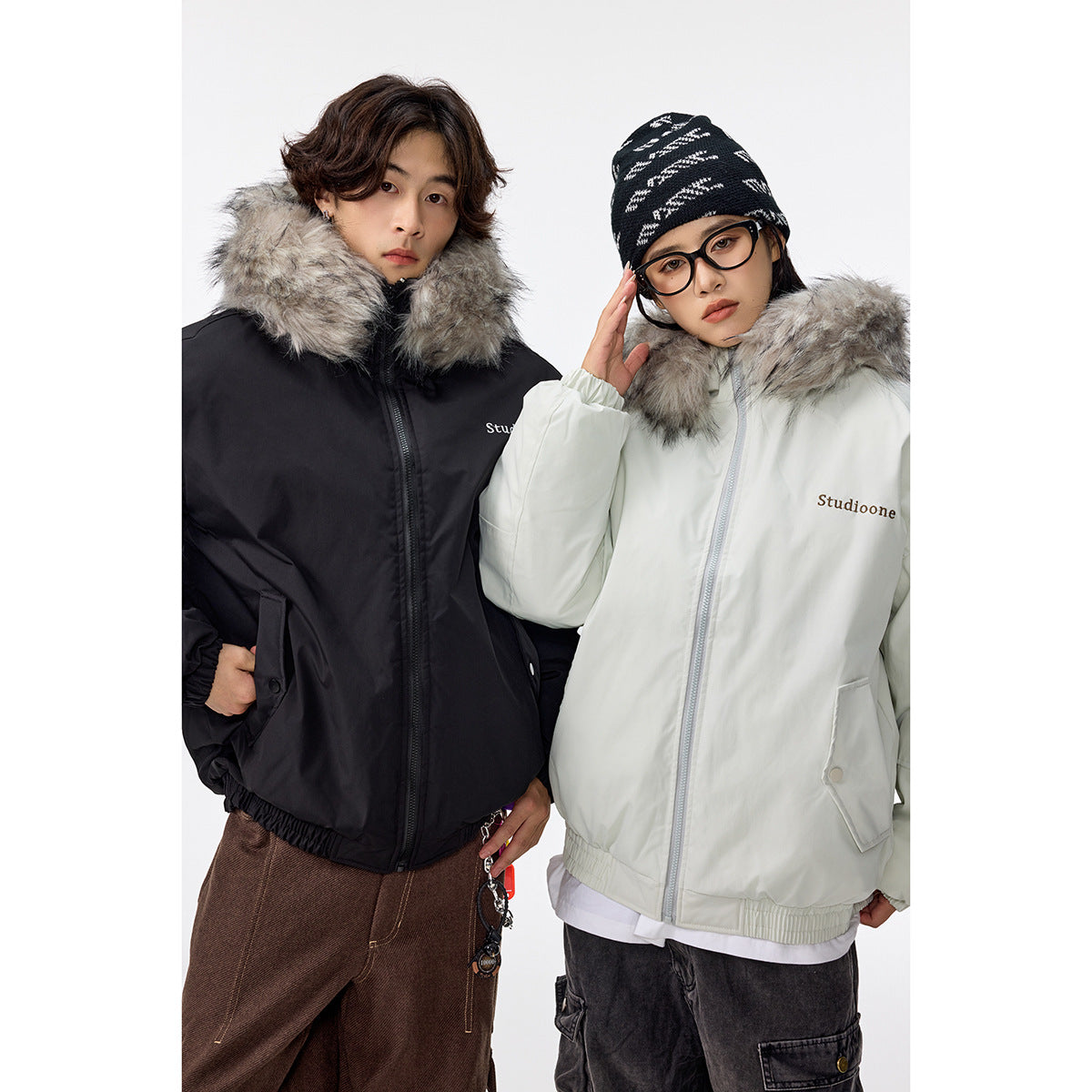Two models show black and pale mint zip-front jackets with gray faux-fur collars, pockets, and elastic hems.