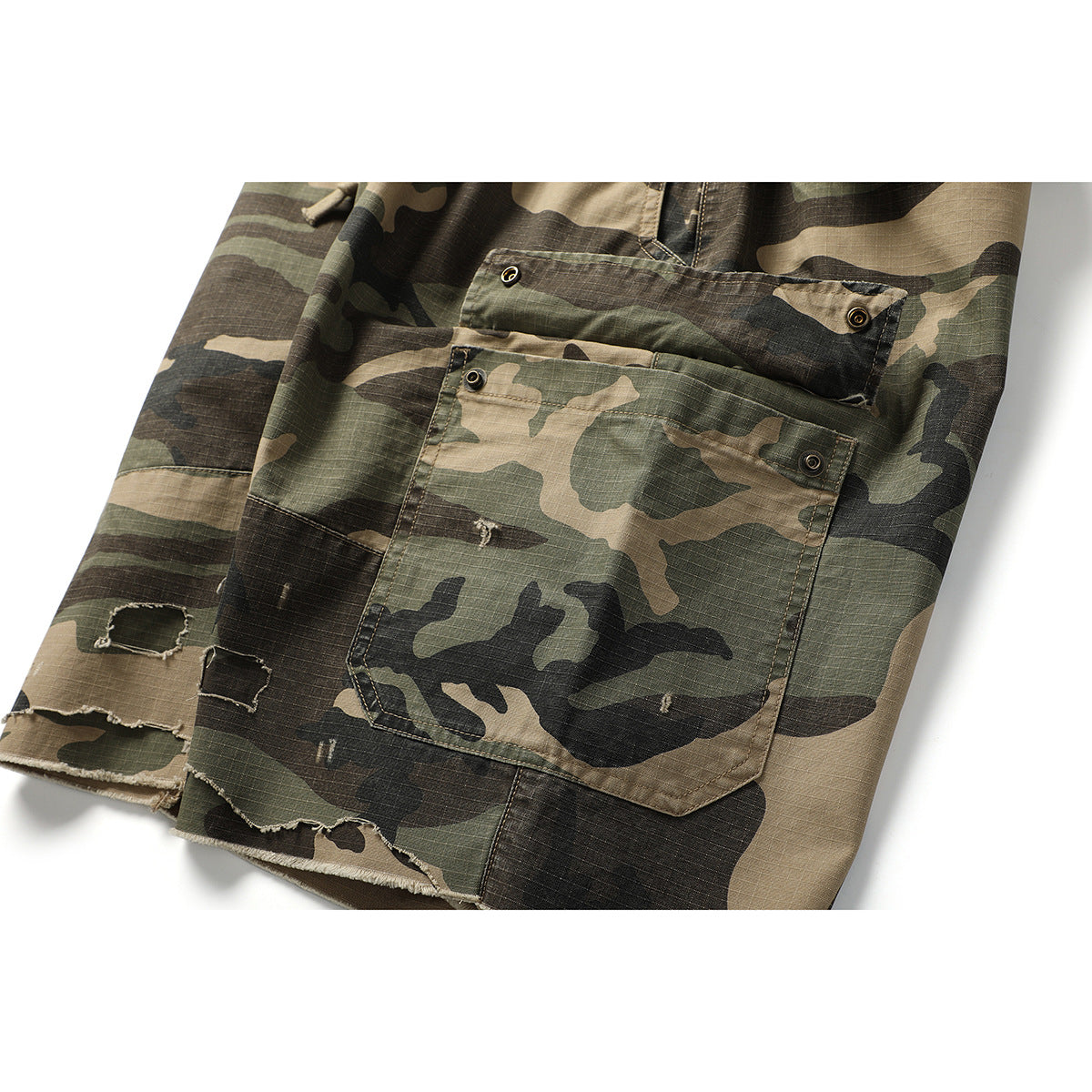 Close-up of camouflage cargo shorts with a large snap-flap pocket and distressed, frayed hem.