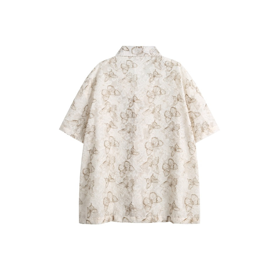 Back view of an ivory short-sleeve shirt with taupe butterfly and floral patterns.