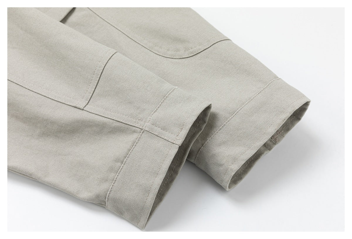 Close-up of the light beige jacket's sleeve cuffs and stitched panel seams.