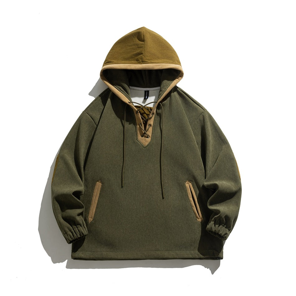 Green corduroy-look hoodie with mustard hood, lace-up V-neck, tan-trimmed pockets and elastic cuffs, flat lay
