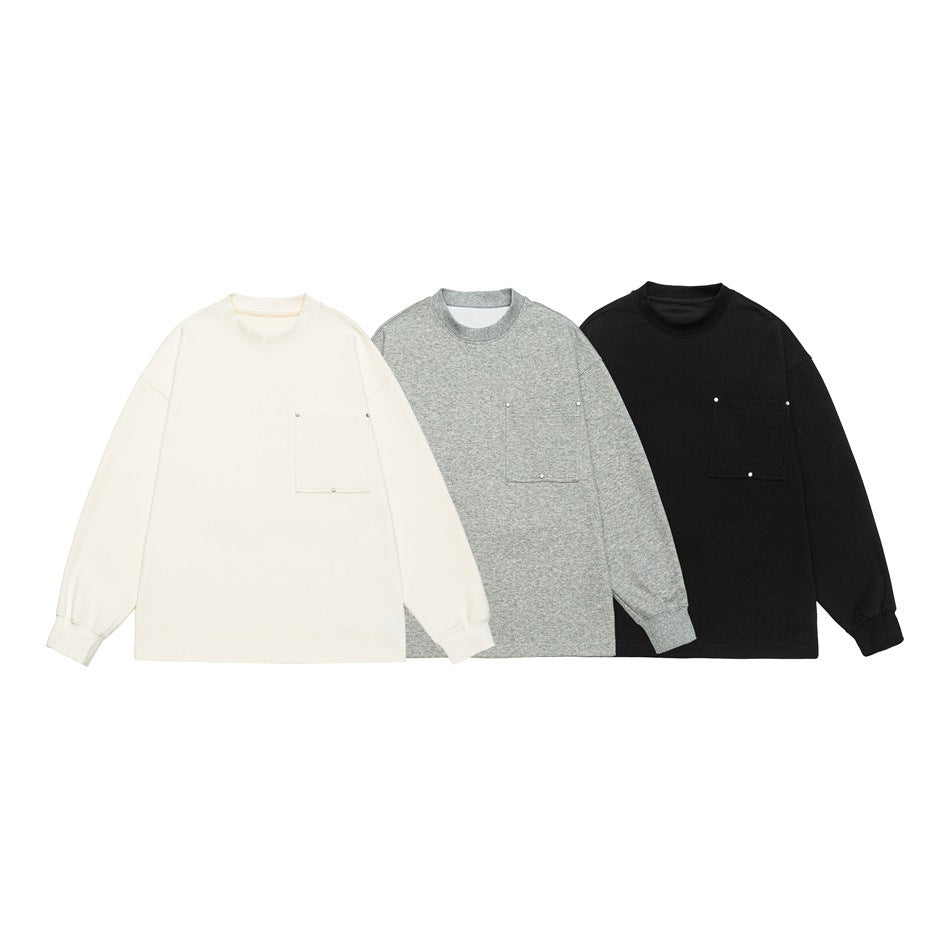 Three crewneck sweatshirts with chest pockets shown together in cream, heather gray, and black.