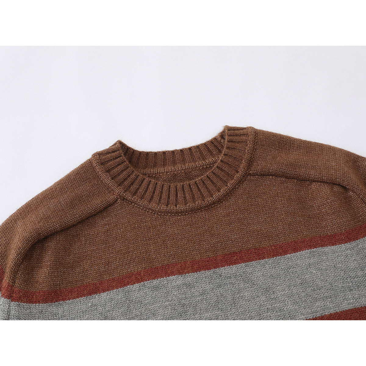 Close-up of a brown knit sweater with a ribbed crew neckline and rust and gray horizontal stripes.