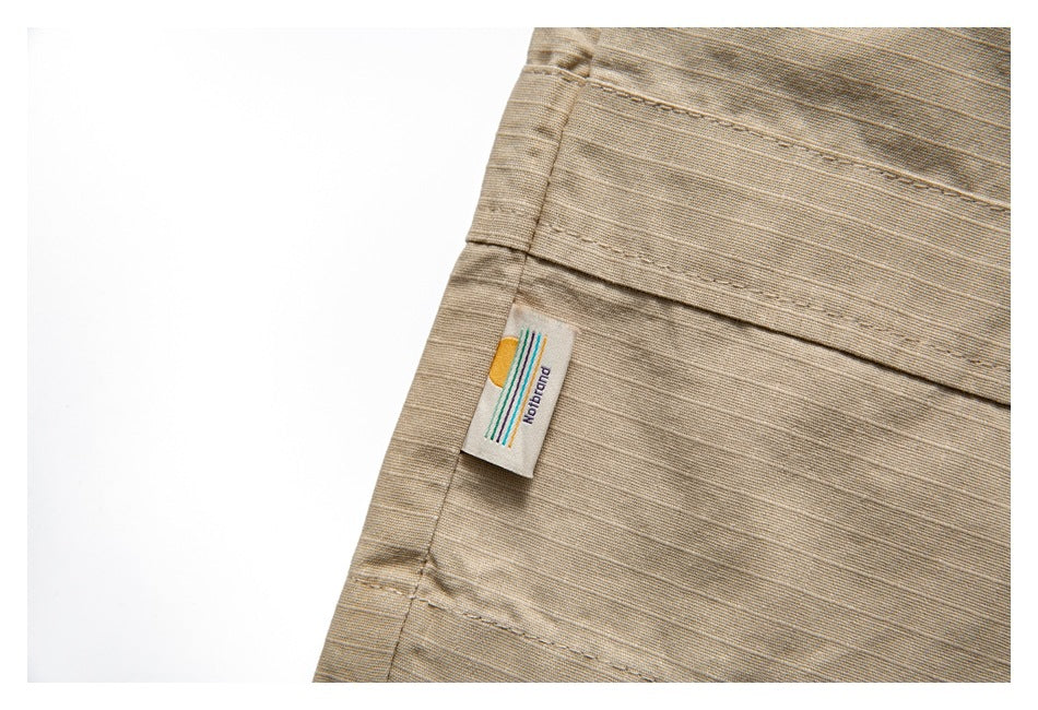 Close-up of a small woven label attached to a tan garment seam.