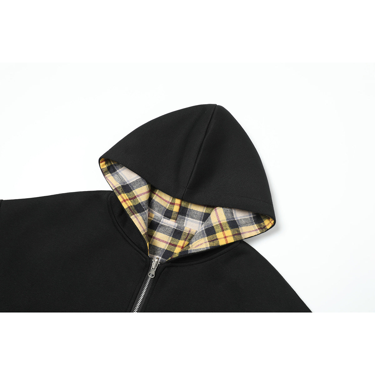 Close-up of a black zip-up hoodie showing its yellow, gray, and black plaid hood lining.