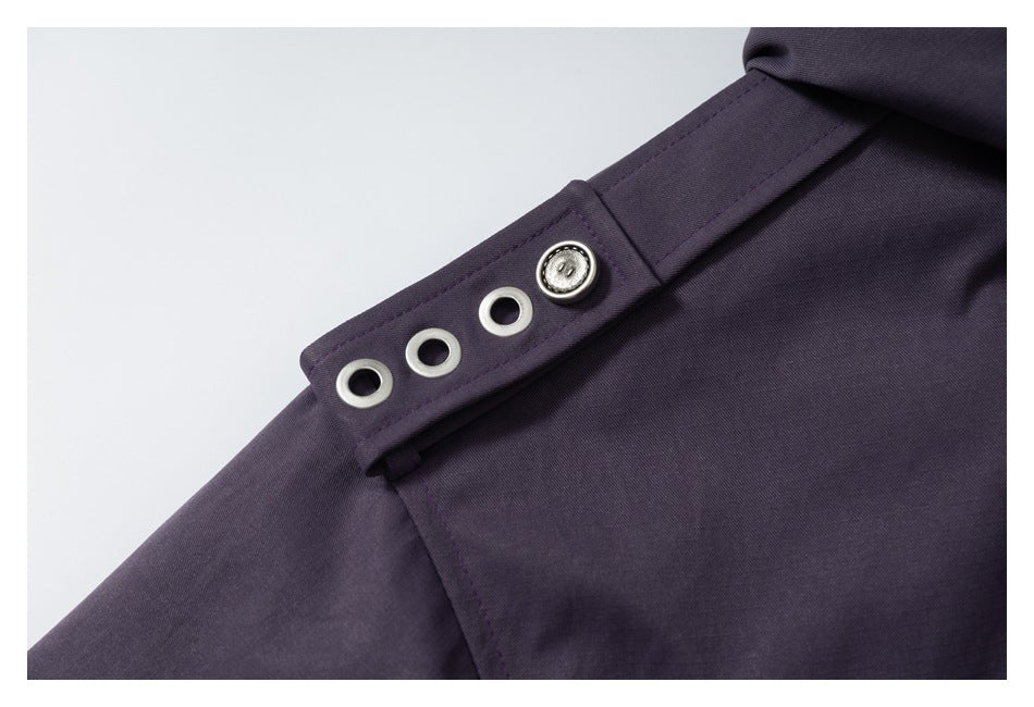 Close-up of a deep plum parka shoulder tab with four metal eyelets and a button.