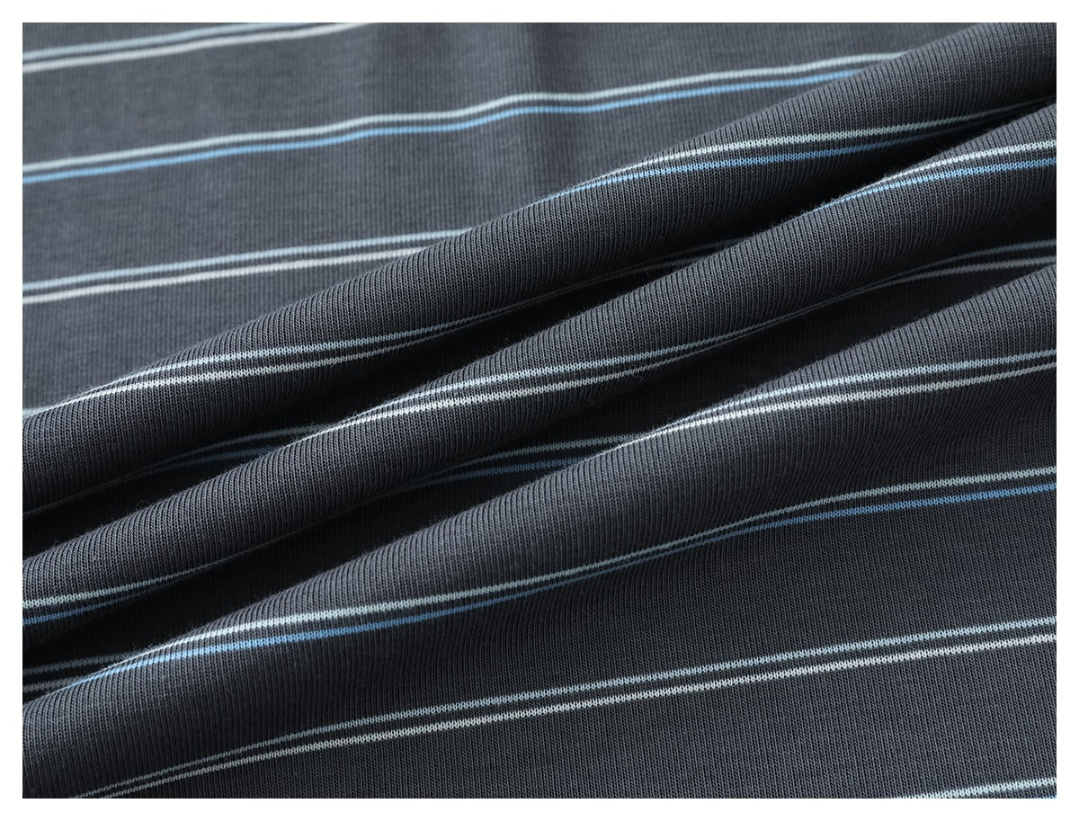 Close-up of draped charcoal gray knit fabric with thin white and light blue stripes.