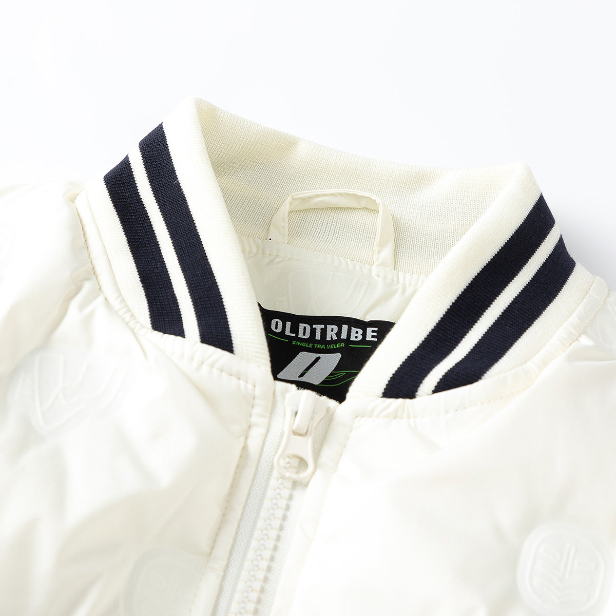 Close-up of an ivory jacket collar with navy stripes, zipper, and a visible inner neck label.