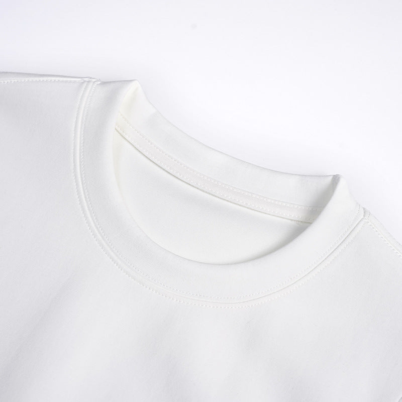 Close-up of a white T-shirt's crew neckline and double-stitched collar.