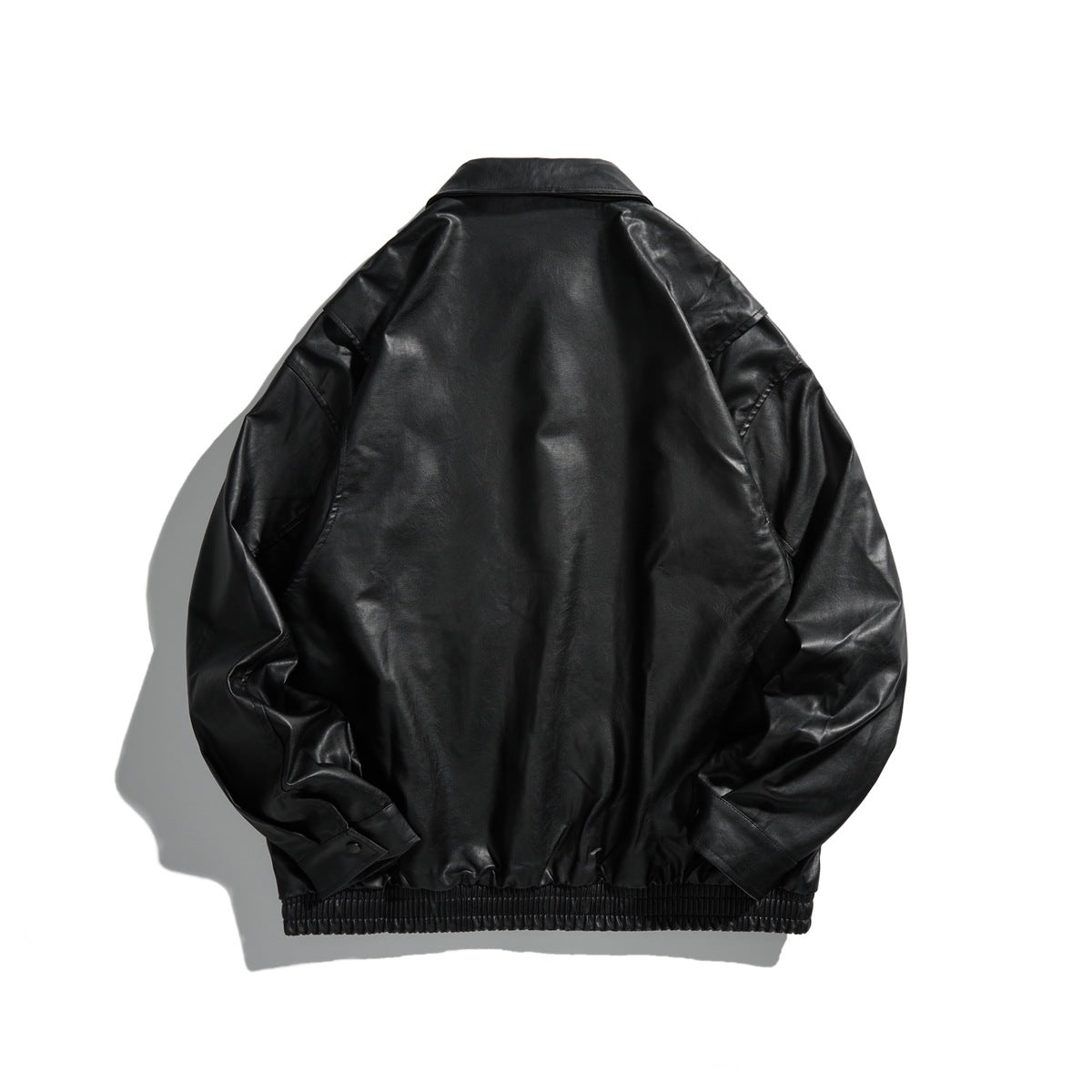 Back view of black glossy faux-leather-look jacket with collar, shoulder tabs and elastic hem