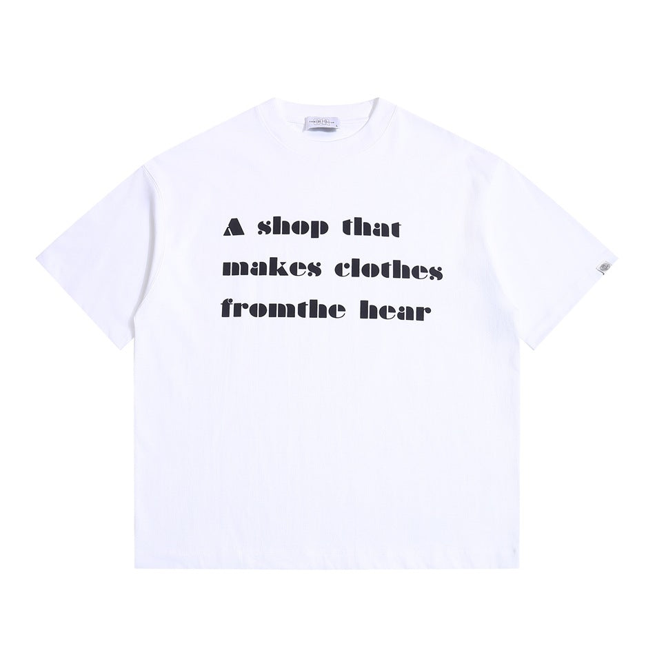 White short-sleeve crew-neck T-shirt with black block-letter slogan print on the front, flat lay