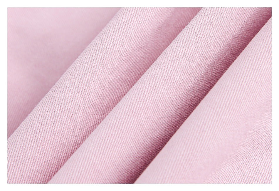 Close-up of the pink garment's textured fabric arranged in soft folds.