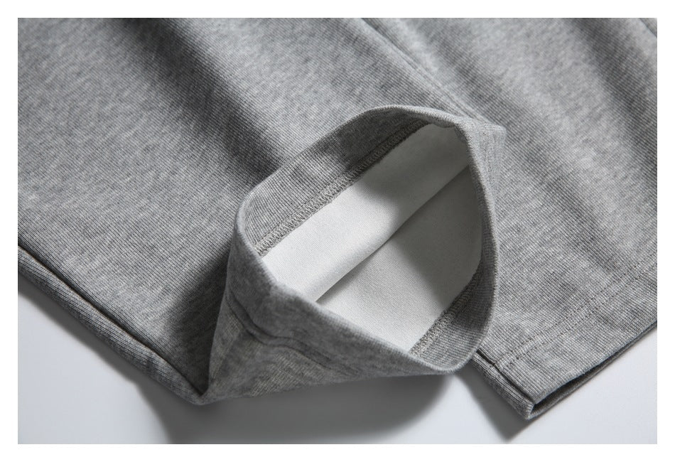 Close-up of a turned-up gray jogger pant leg showing the inside of the hem.