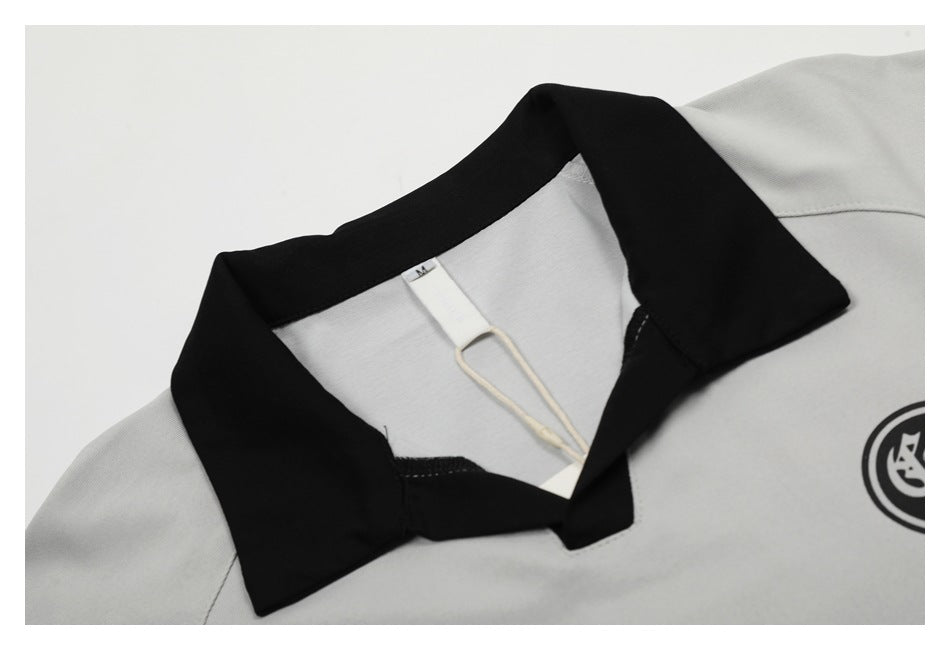 Close-up of the shirt's black collar, neckline stitching, and inner size tag marked M.