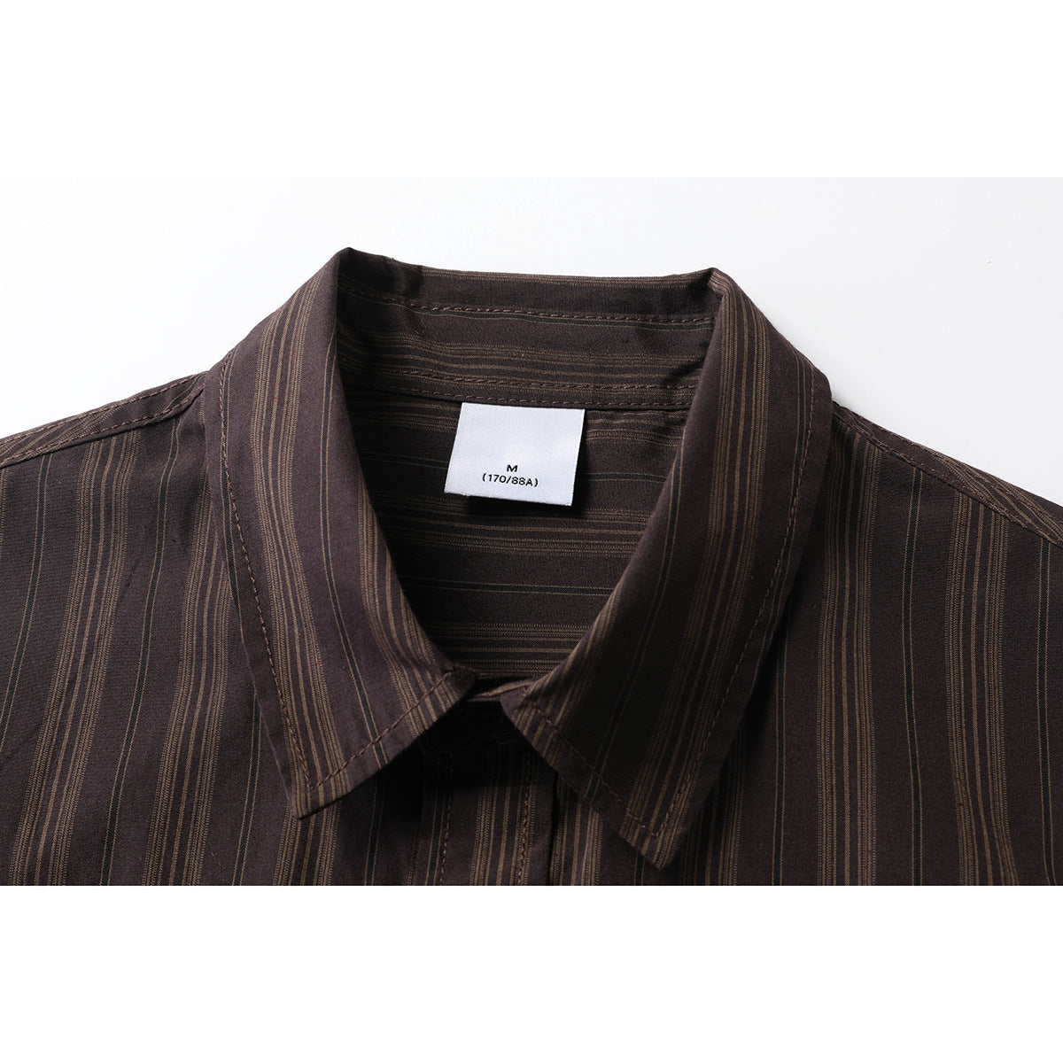 Close-up of a dark brown striped shirt collar with a sewn size label marked M, 170/88A.