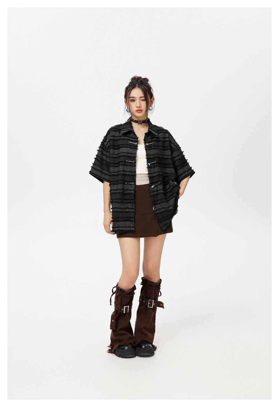Model wearing the striped frayed-texture shirt open with metal fasteners, styled with a brown skirt and leg warmers
