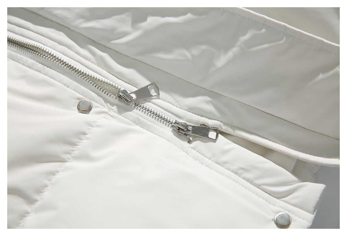 Close-up of a white jacket with a silver two-way zipper and metal snap fasteners.
