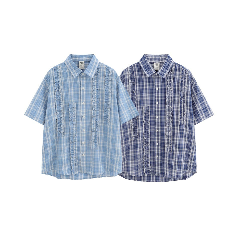 Two short-sleeve plaid button-up shirts with ruffle trim, shown in light blue and dark blue colorways.