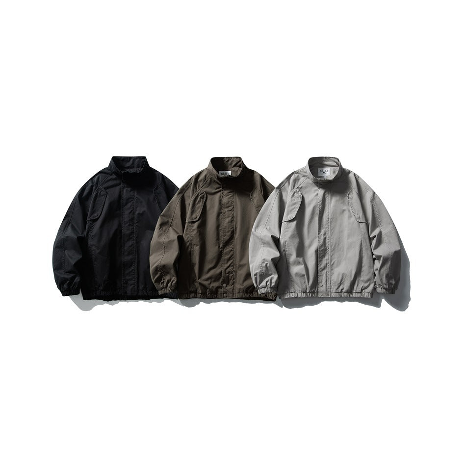 Three zip-front jackets displayed together in black, dark taupe, and light gray.
