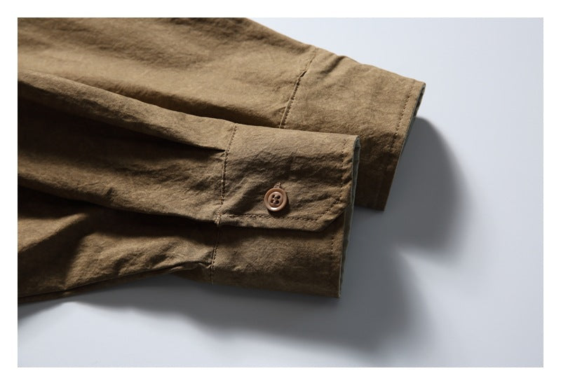 Close-up of the brown shirt’s sleeve cuffs, showing button closures and stitching.