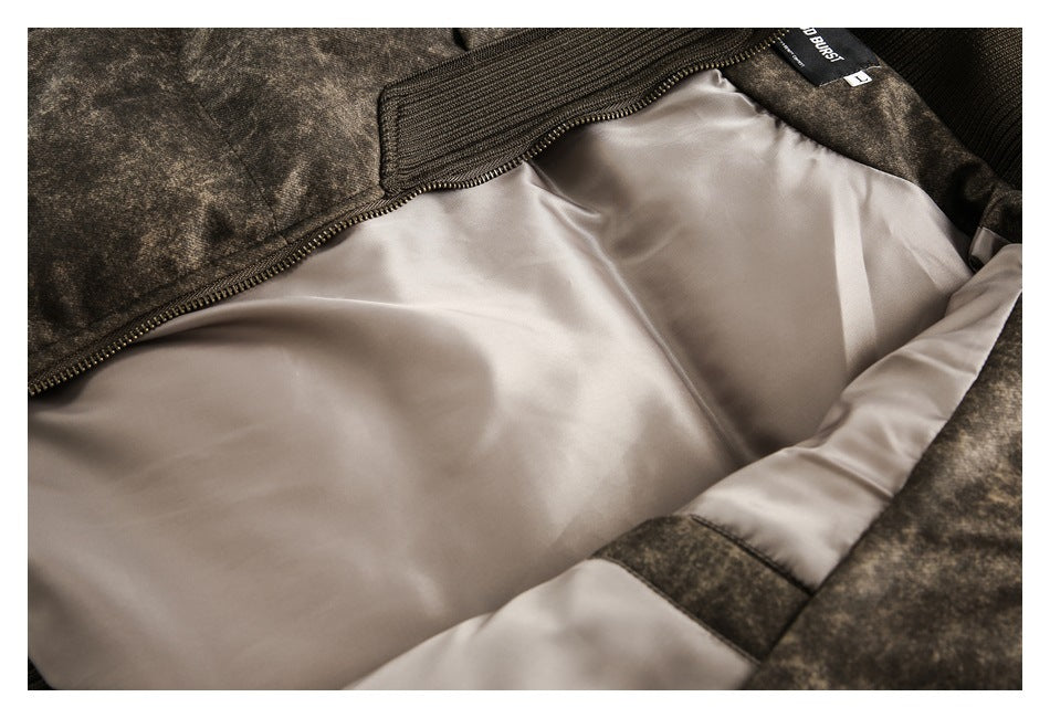 Close-up of the jacket’s light beige lining, brown mottled outer fabric, ribbed trim, zipper, and interior label.
