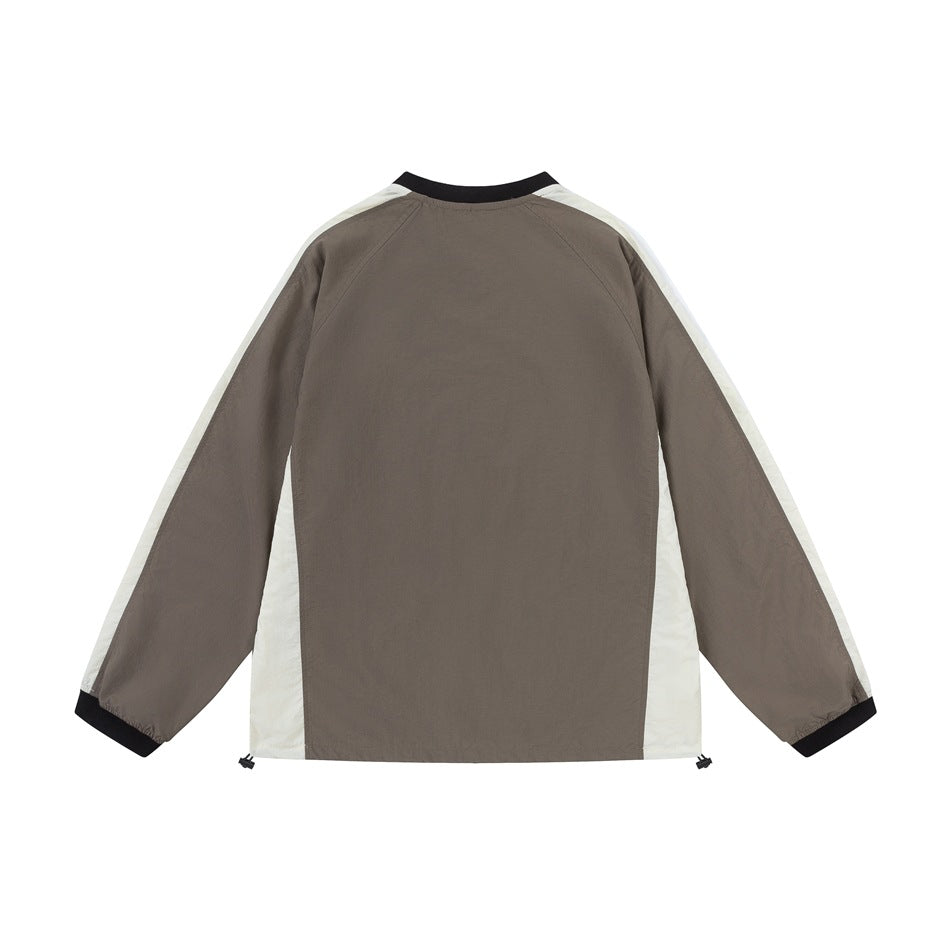 Back of a taupe long-sleeve top with off-white side and sleeve panels, black ribbed collar and cuffs, and hem drawcords.