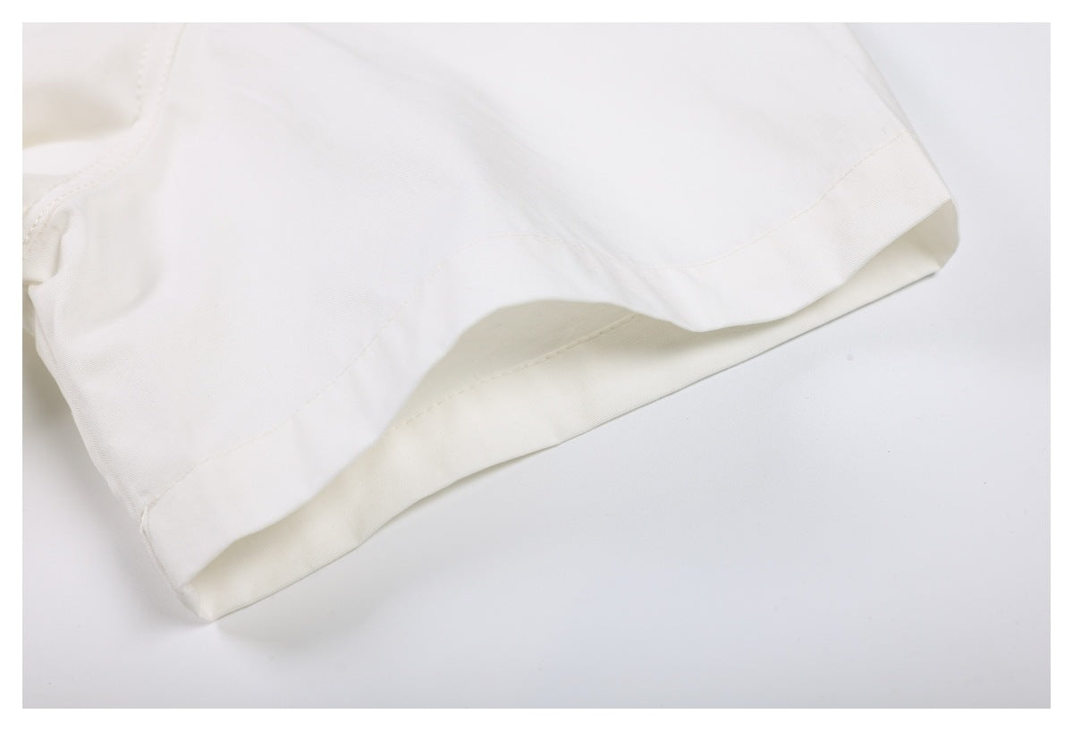 Close-up of a white short sleeve with a wide stitched hem.