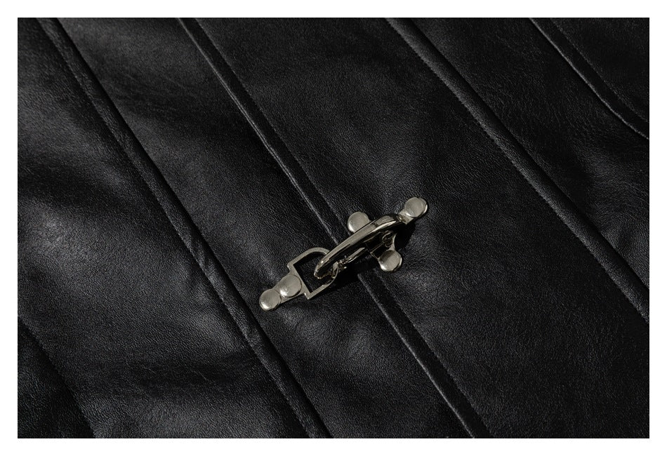 Close-up of a metal toggle fastening on the black jacket's front panels.