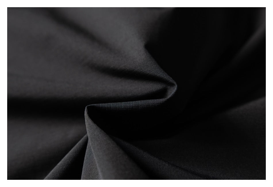 Close-up of smooth black fabric folded into soft folds.