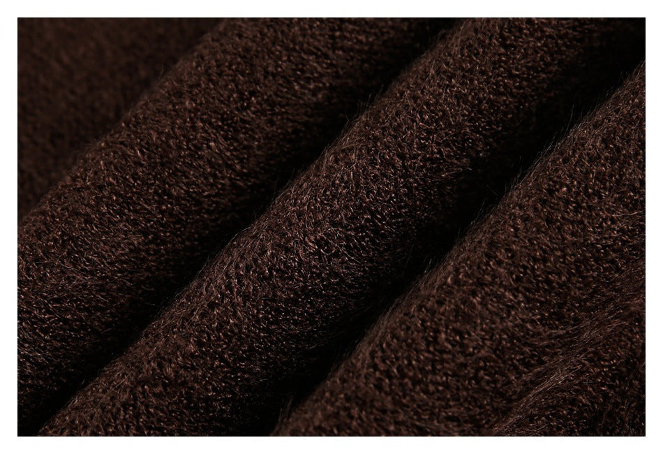 Macro close-up of dark brown textured fabric arranged in soft folds.