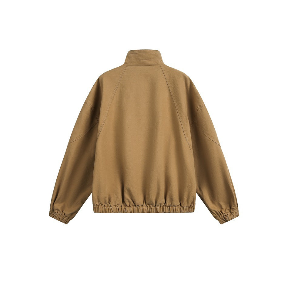 Back view of a tan jacket on a white background, showing its stand collar, raglan seams, elastic cuffs, and gathered hem.