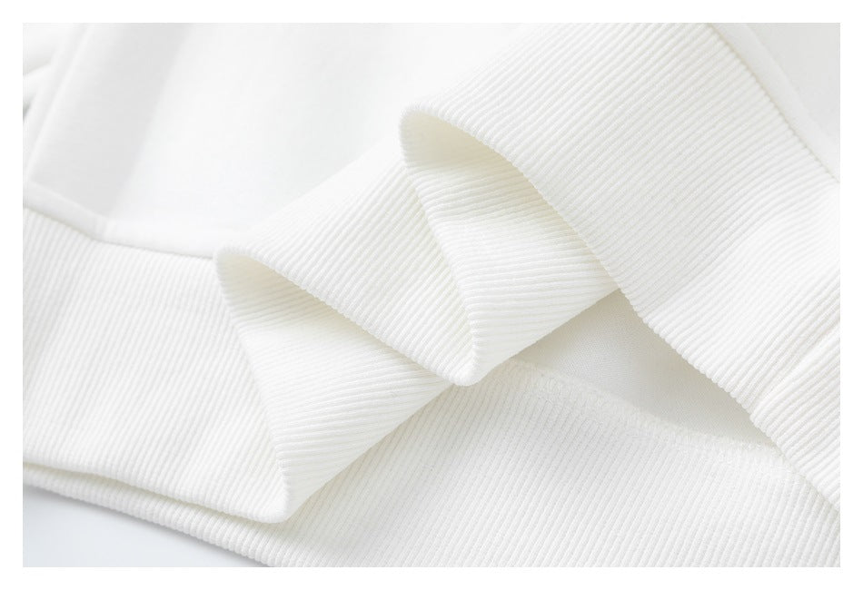 Close-up of the white sweatshirt’s ribbed neckline and collar.