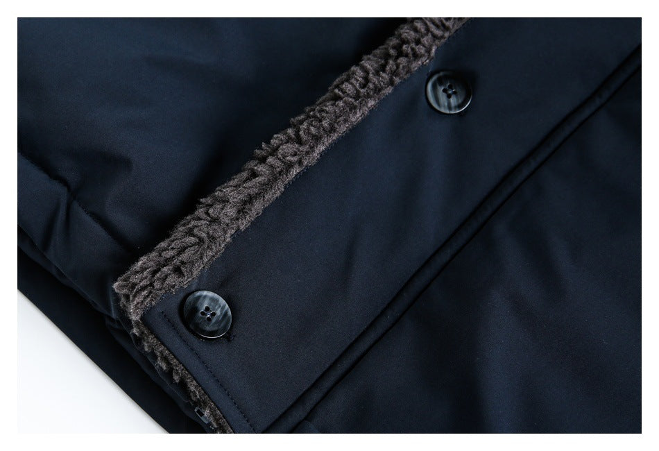 Close-up of dark navy fabric, two buttons, and a strip of fuzzy trim along the garment edge.