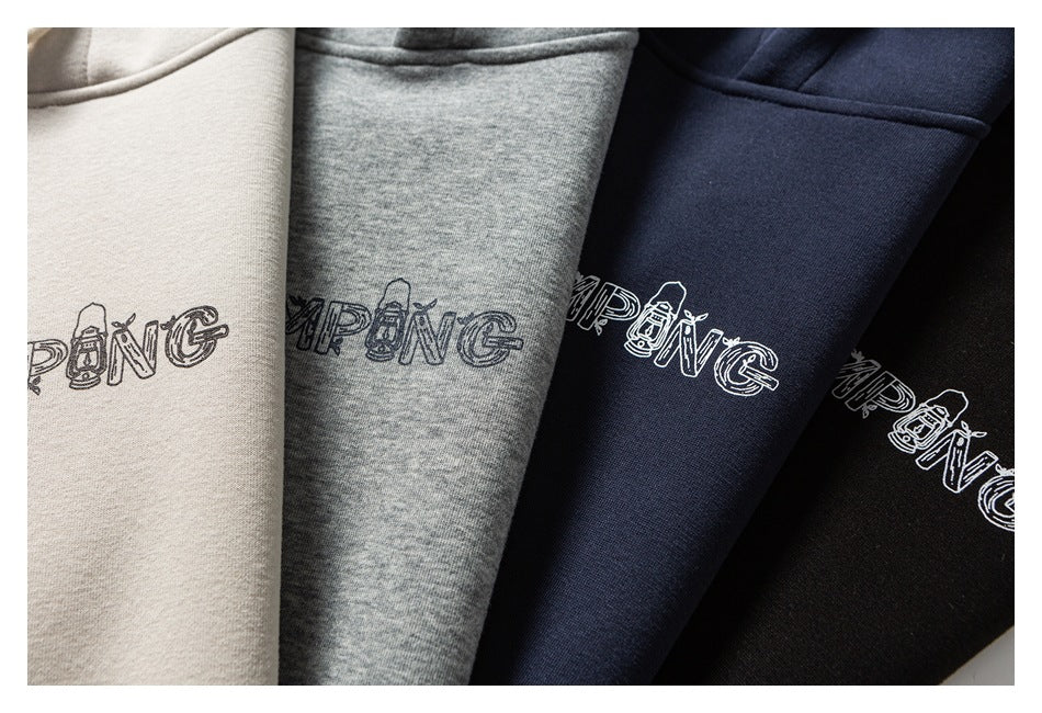 Close-up of four hoodies in cream, heather gray, navy, and black, showing matching outlined camping text across the chest.