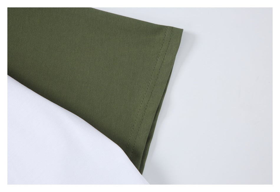 Close-up of an olive-green sleeve and its stitched hem against white fabric.