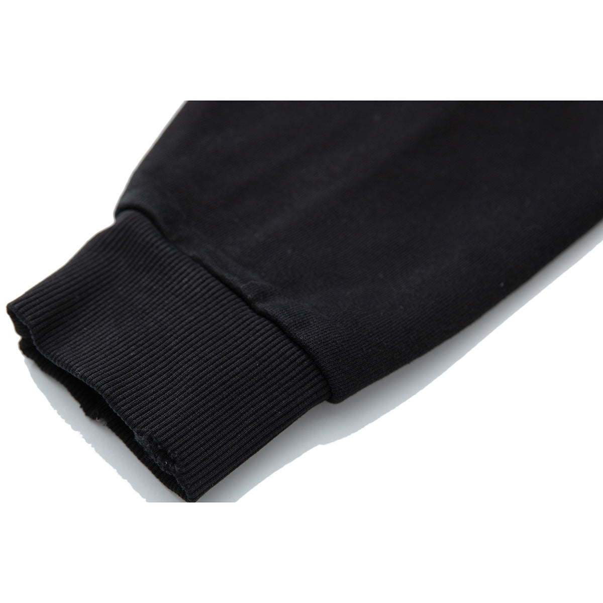 Close-up of a black sleeve ending in a ribbed cuff.