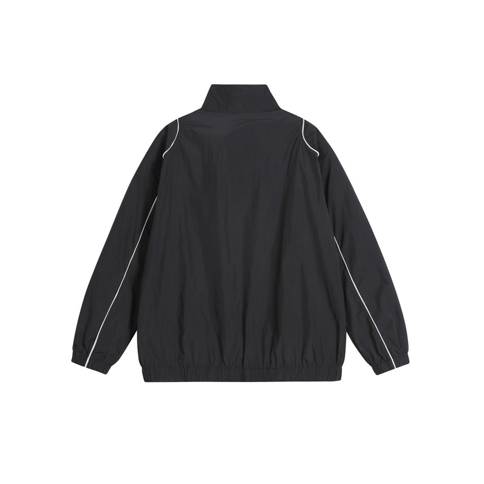 Back view of a black jacket with a high collar, elastic cuffs and hem, and white piping.