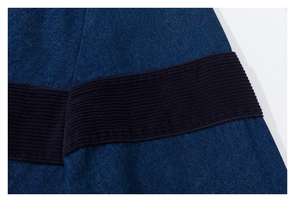 Close-up of a wide dark ribbed panel across dark indigo denim.