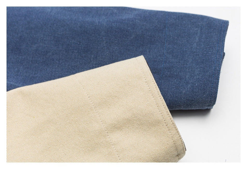 Close-up of blue and beige fabric sections with visible weave and stitching.