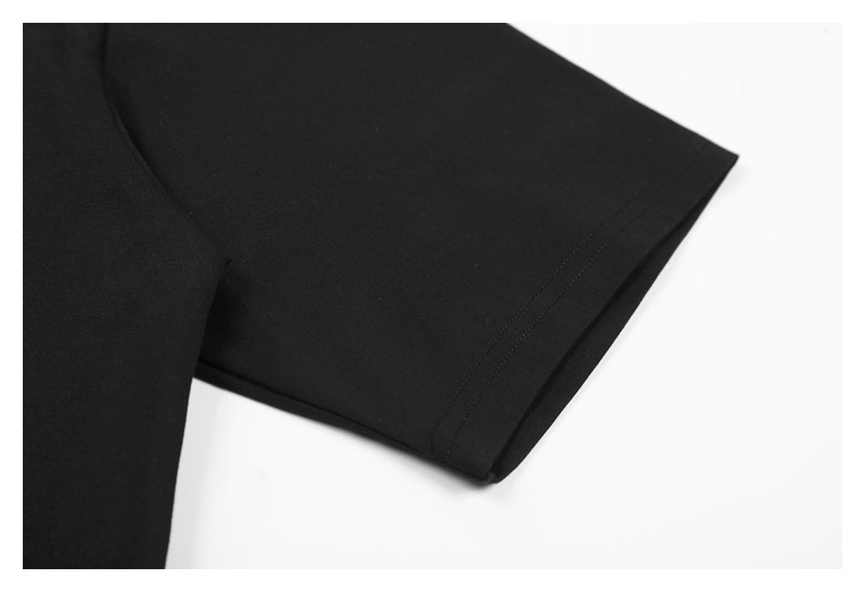 Close-up of a black shirt sleeve and its double-stitched hem on a white background.