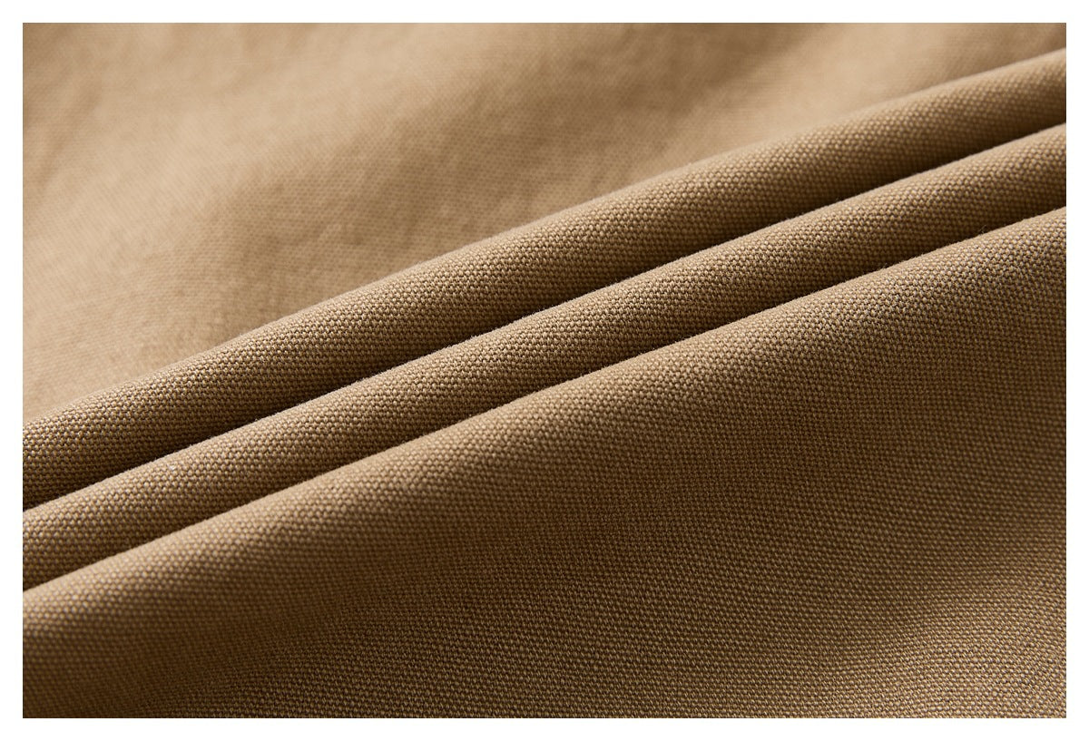 Close-up showing the textured weave and folds of tan-brown garment fabric.